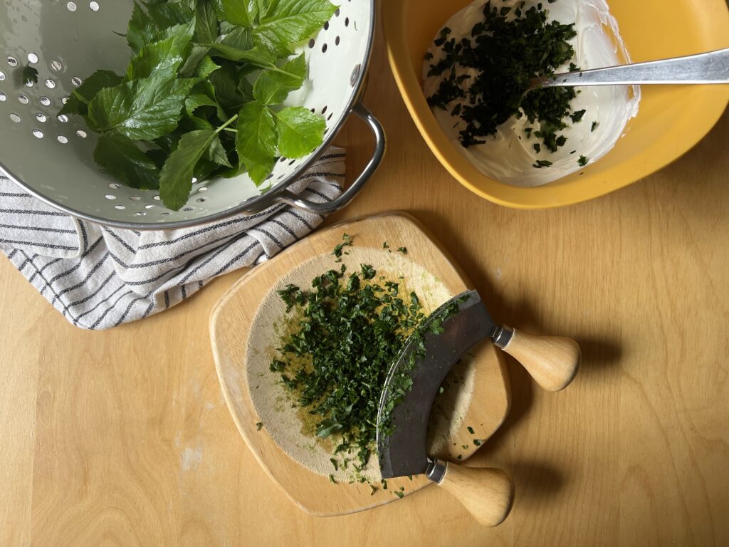 chopping up herbs for wild garlic, ground elder and parsley cheese spread